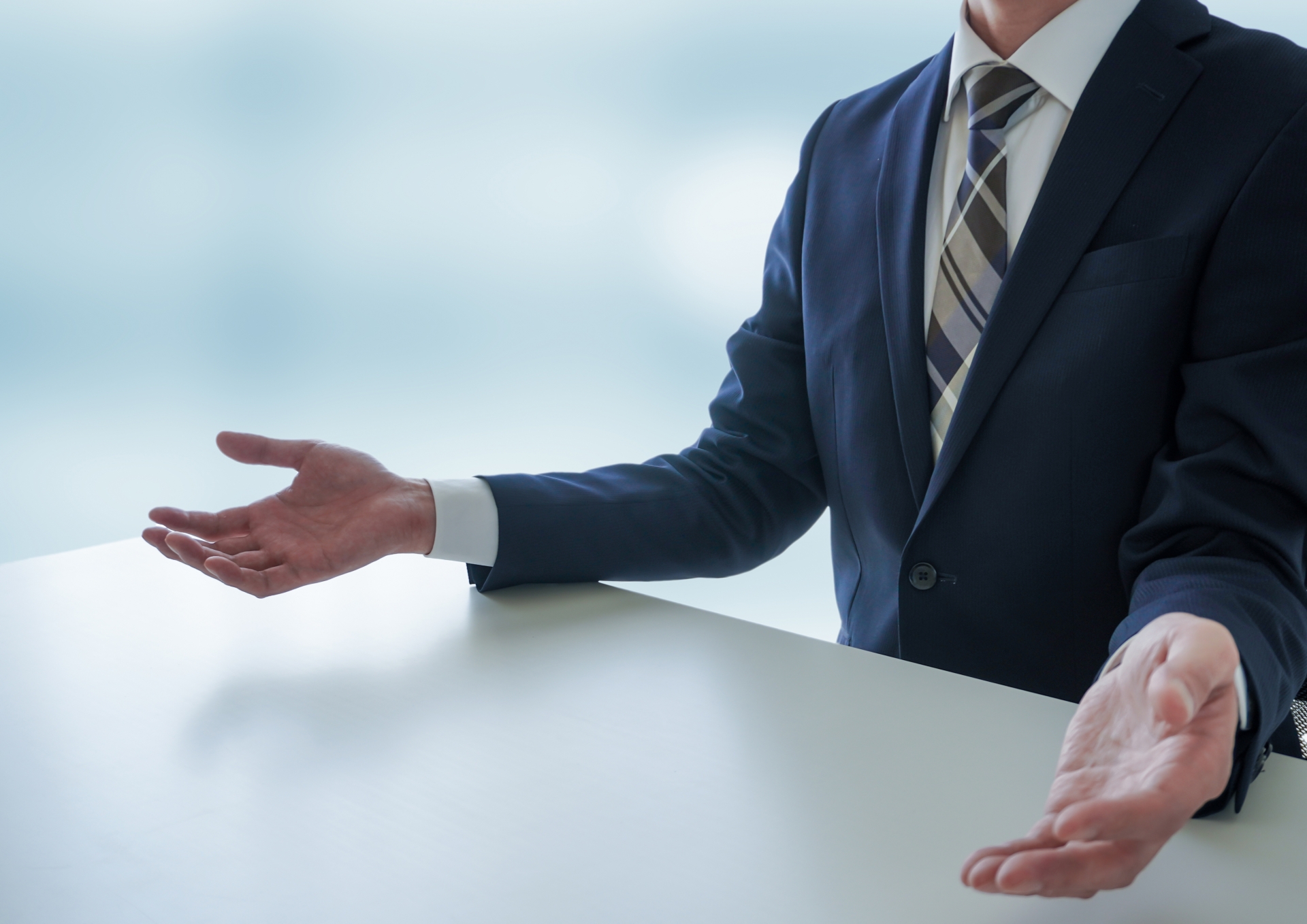 手を広げ話すビジネスマン